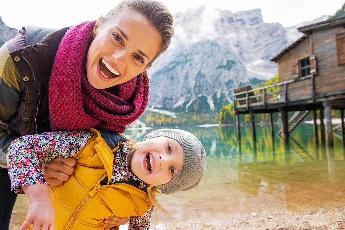 A mum and child having fun by the lake