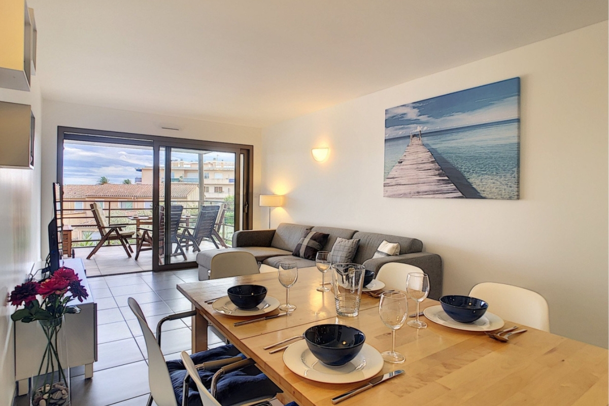 The lovely living room of the Apartment At Art De Vivre with dining area and furnished balcony 