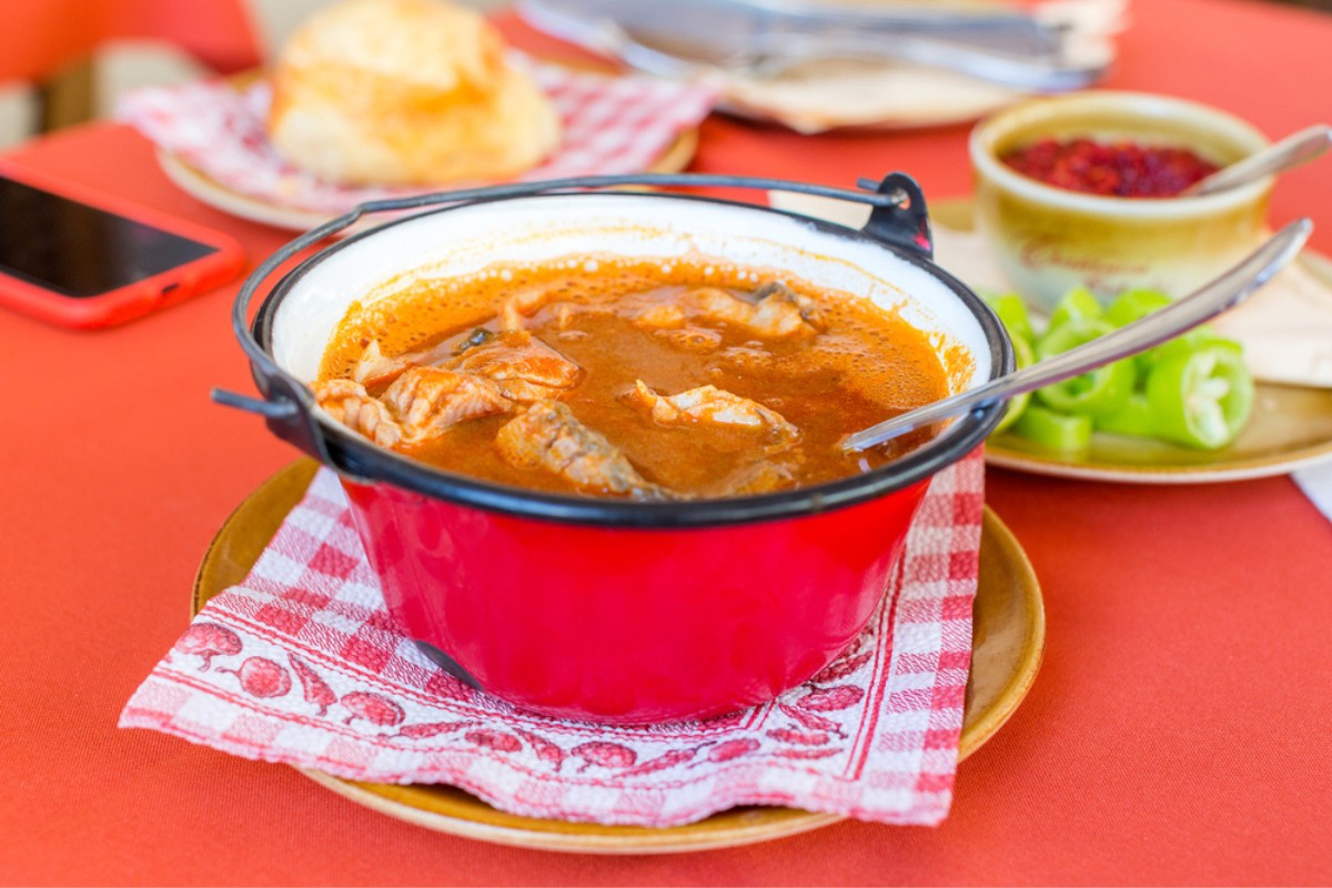 Traditional Croatian fish soup, fiš paprikaš in a small red kettle