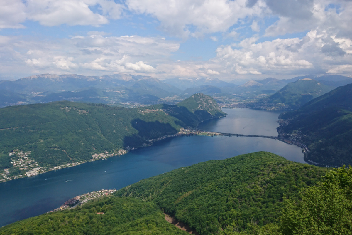 Marvelous view on Lago di Lugano and the city of Lugano from Monte San Giorgio summit in the Lepontine Alps on a delicately shrouded Spring day in a mix of light and shadow - Ticino - Switzerland